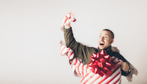 A man breaks free from wrapping paper