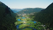 aerial view over a river and community in a valley in summer 