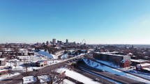 Aerial footage of Saint Louis, Missouri on a cold and snowy winter morning with clear blue skies and snow on the ground.