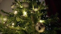 Christmas tree adorned with silver and white balls and lights 