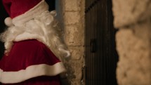 Santa Claus knocking on an ancient door 