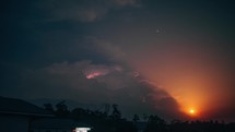 Time lapse of a lightning storms in the clouds as a summer moon rises
