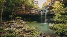 Time-lapse of a secluded waterfall cascading into a beautiful pool
