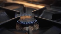 Cooker with gas flame glowing inside a kitchen 