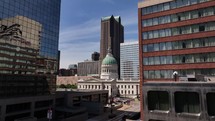 Drone footage looking at the Old Courthouse building in downtown Saint Louis, Missouri on a beautiful blue sky summer day.