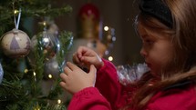 Little Girl decorating Christmas tree 