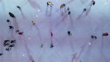Top view of people skating on large open air ice rink