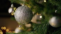 Silver ball decoration hanging on a christmas tree 