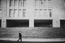 a man walking in front of a building