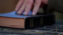 Close up of a man looking up a Bible scripture