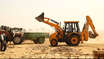 a bulldozer moving sand in a construction site 