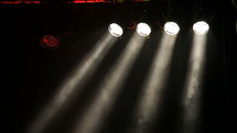 Concert stage with withe spotlights and smoke