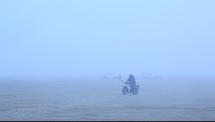 a man riding a dirt bike through a desert 