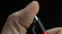 Close up of a man nervously clicking his pen