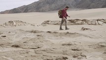 a man hiking alone through the desert 