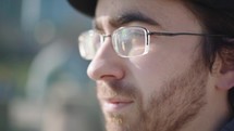 Close up of a contemplative  young man looking towards the sun