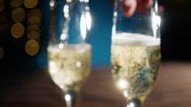 Blurred Background of two glasses filling with champagne