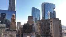 Drone view flying in towards skyscraper buildings in downtown city of Houston, Texas on beautiful blue sky no clouds morning.