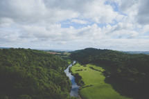 aerial view over a river and forest 