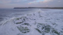 Crashing sea waves at sunset