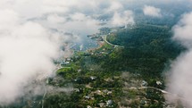 aerial view in the clouds over a lakeside community 