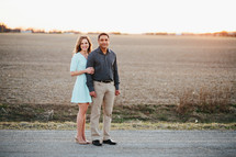 a couple standing on a rural road 