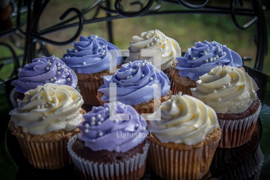 purple and white icing on a cupcakes 