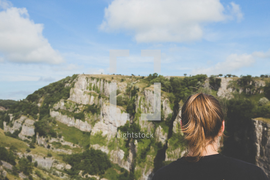 woman at the top of steep cliffs 