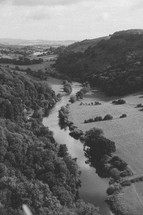 aerial view over a river and forest 