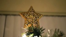 gold star on the top of a Christmas tree