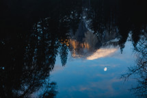 Reflection of snowy mountain in Yosemite and moon