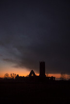 silhouette of church ruins at sunset 