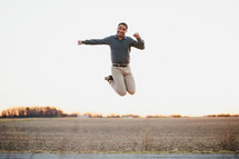 a man jumping in a field 