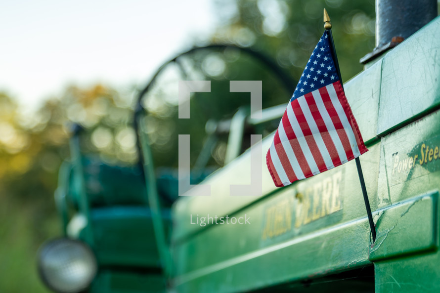 American flag on the side of a green tractor 