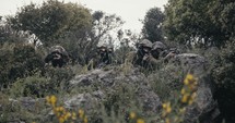 Israeli soldiers in a surveillance and reconnaissance mission using binoculars