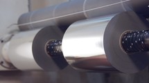 Large industrial printing machine splicing rolls of shiny paper