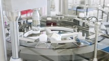 Automated pharmaceutical manufacturing line, bottles filled with liquid