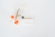 roses, antlers, and white coin purse 