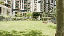 A beautiful garden inside an urban area with water streams, flowers and trees