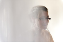 white light on a bride in glasses