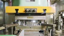 A large industrial punch press forming high precision metal parts for the automotive industry