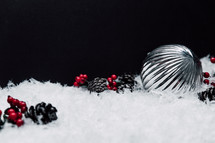 silver ornaments in snow 