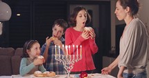 Mother bringing her children donuts during Hanukkah.