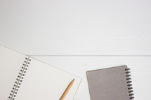 pencil and notebooks on a white background 