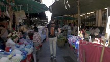 people shopping at an outdoors market 
