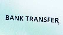 Bank transfer typed on a computer screen - macro shot