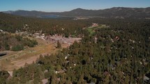 Aerial Shot of Forest with Big Bear Lake in the Background