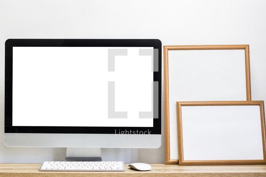 blank computer screen and framed signs 