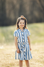 portrait of a little girl in a striped dress 