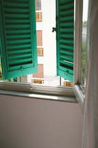 green shutters on a window 